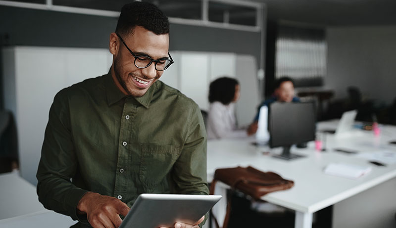 young African American male office worker holding a tablet