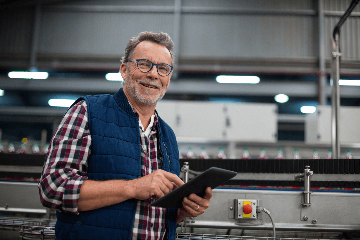 older adult make in a flannel shirt and blue vest