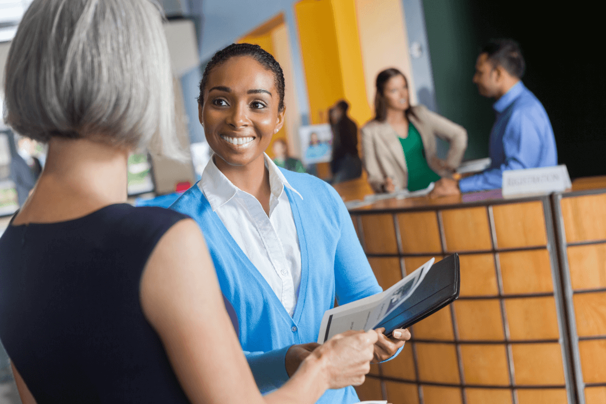 two woman talking in a reception area