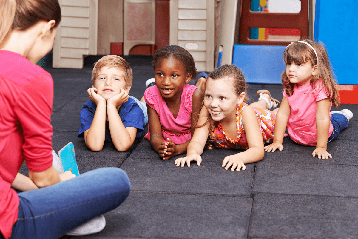 female teacher talking to children in a classroom