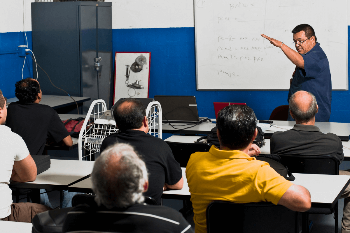 instructor at the front of a classroom of older adults