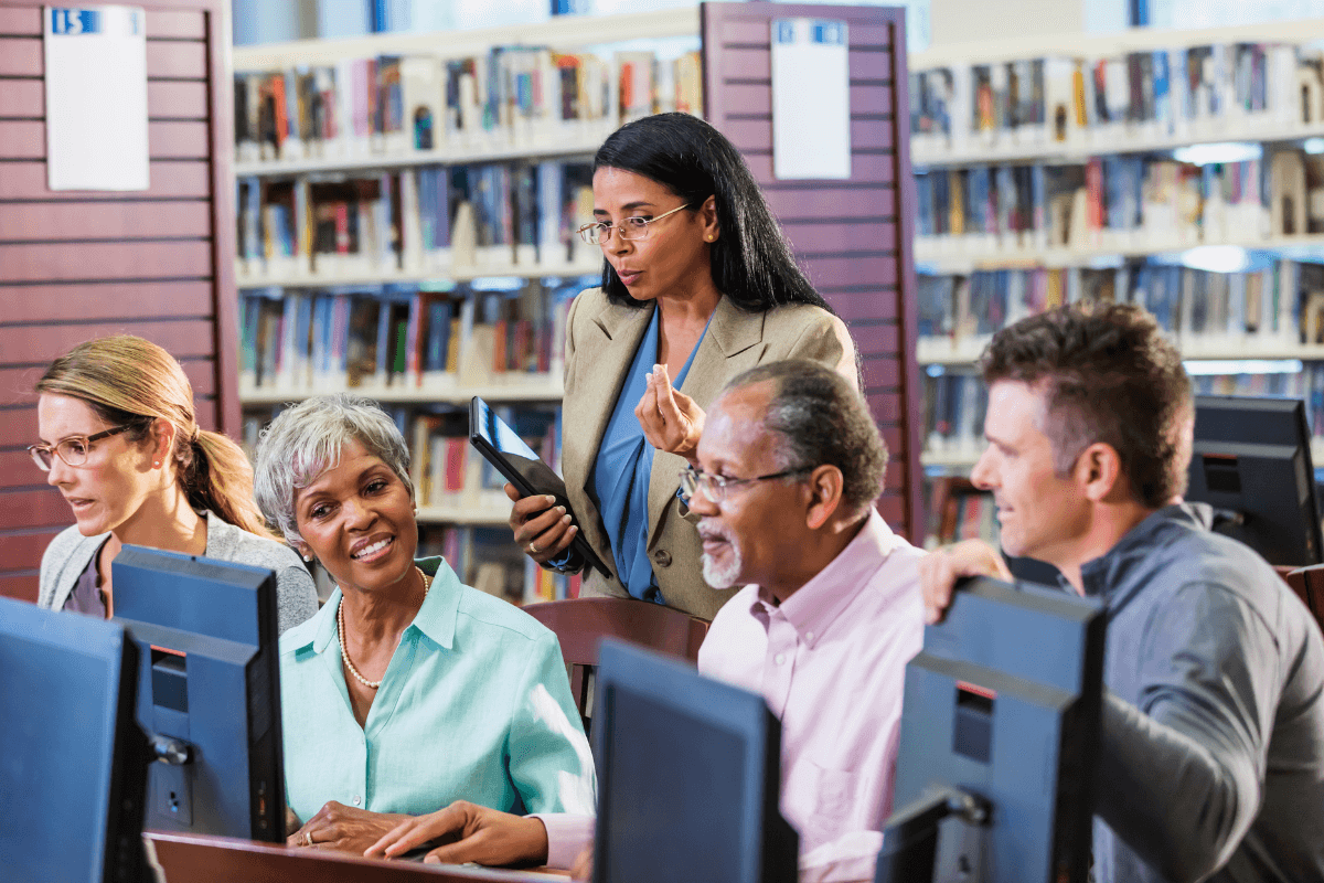 diverse group of adults sitting at computers