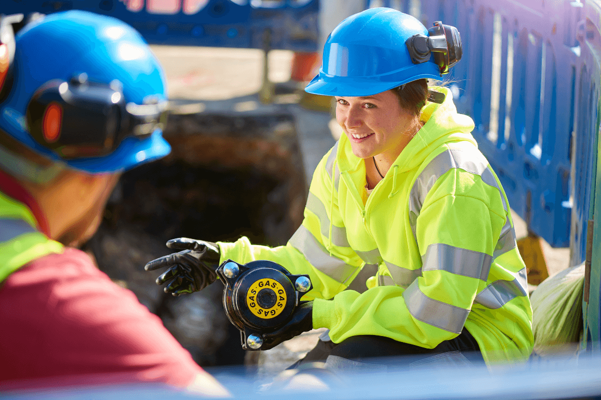 man and woman in high visibility vest and hard hats