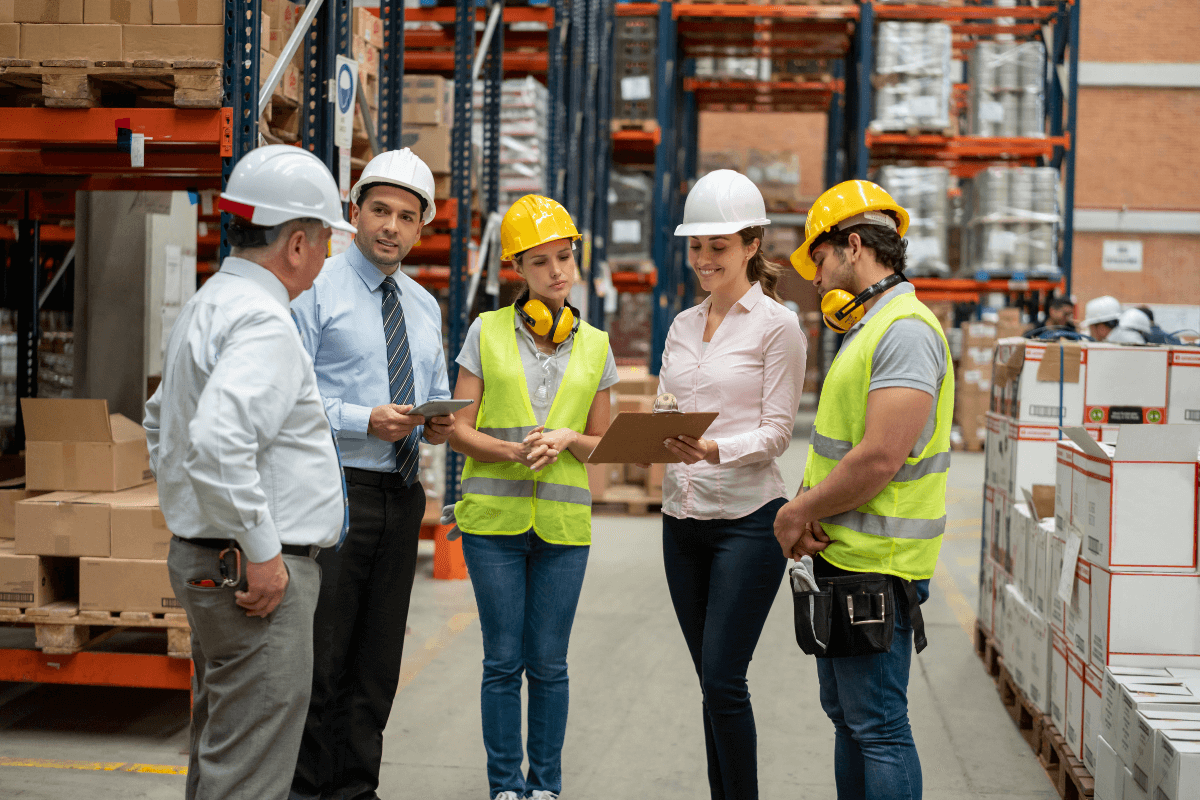 group of employees standing together in a warehouse