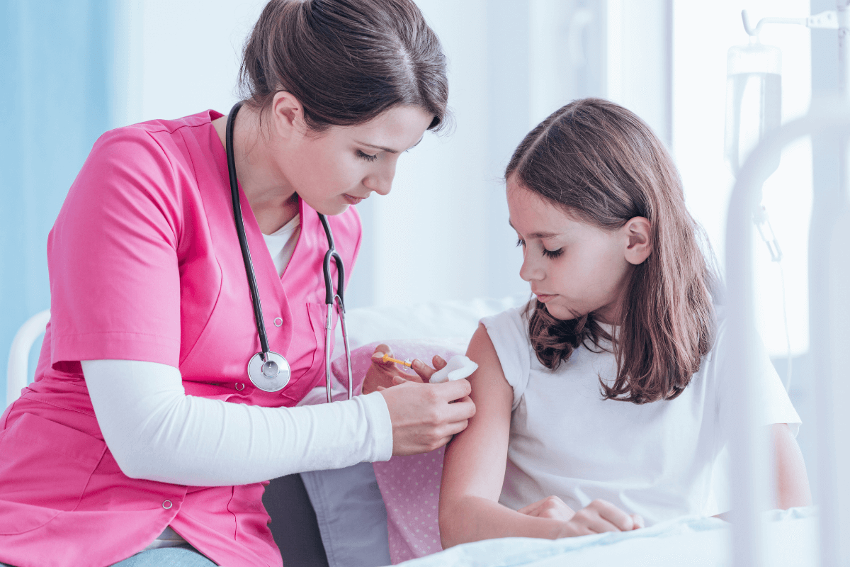 female nurse helping a young girl