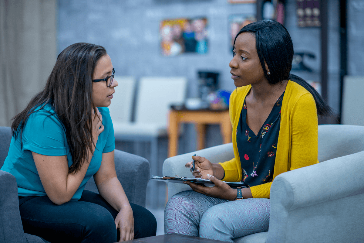 two women sitting in a lobby doing an interview